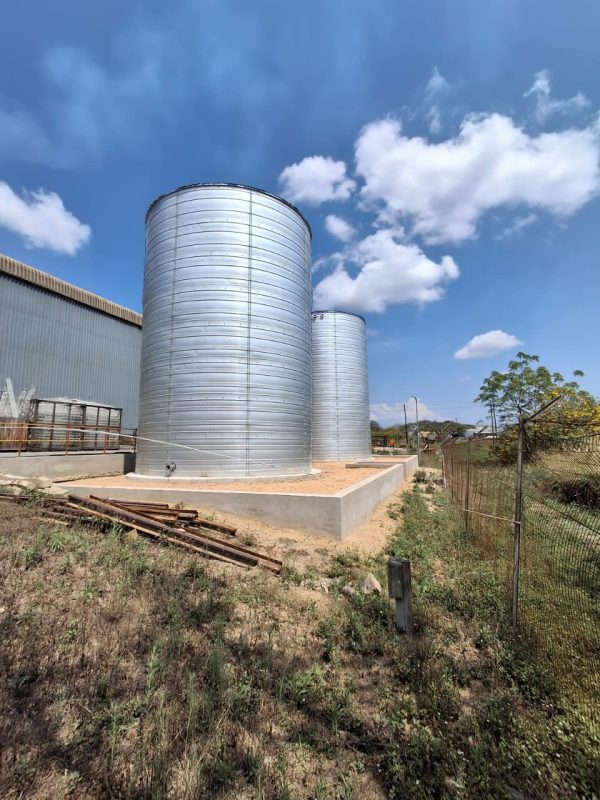 Tall tanks beside a warehouse